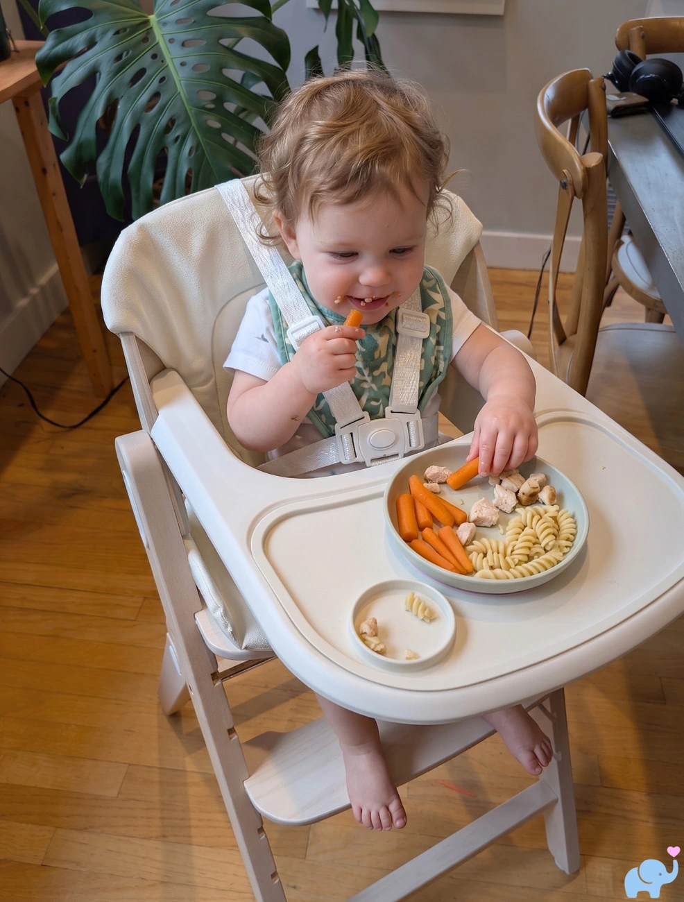 11 month old baby boy eating noodles and carrots in Mamazing GrowPod high chair