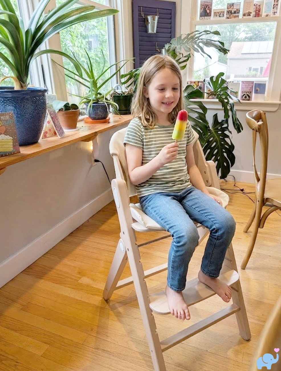 six year old girl sitting in Mamazing GrowPod eating a popsicle