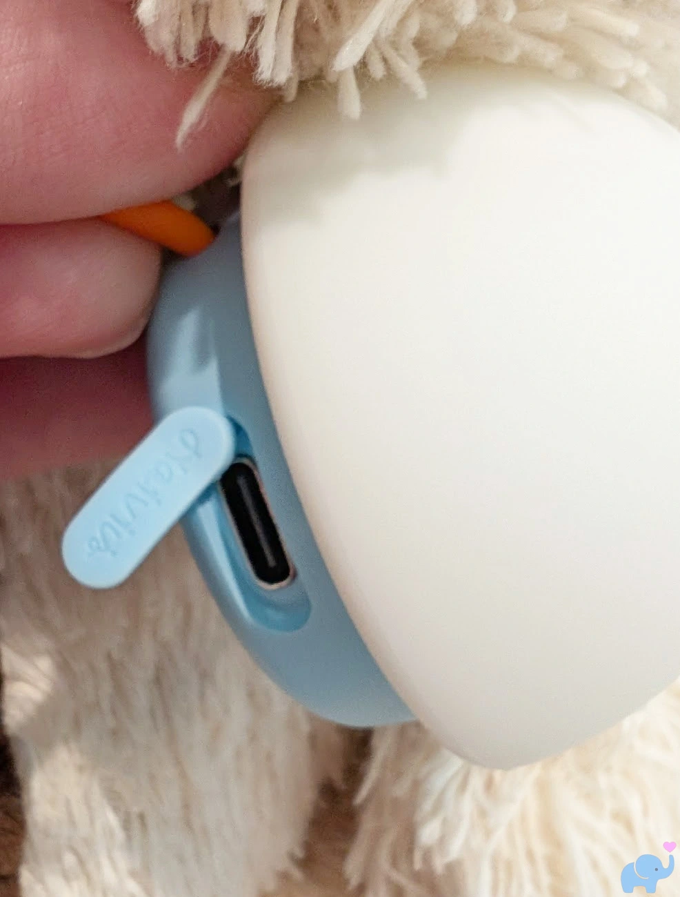 close up of the charging port on the side of the haivivi bubblepal ai companion toy