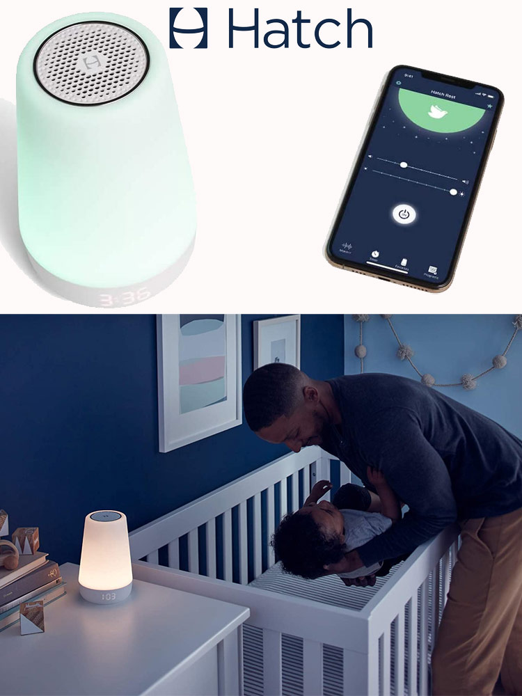 a father lowering a baby to sleep in the crib next to a hatch rest plus