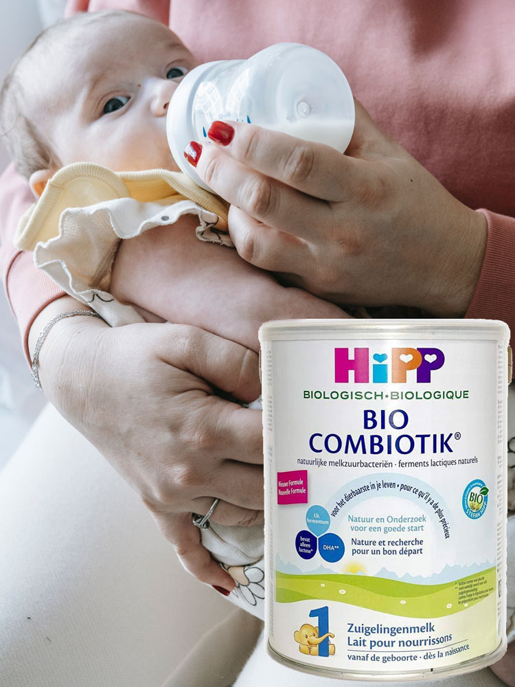 mother feeding a baby hipp combiotik organic infant formula from a bottle