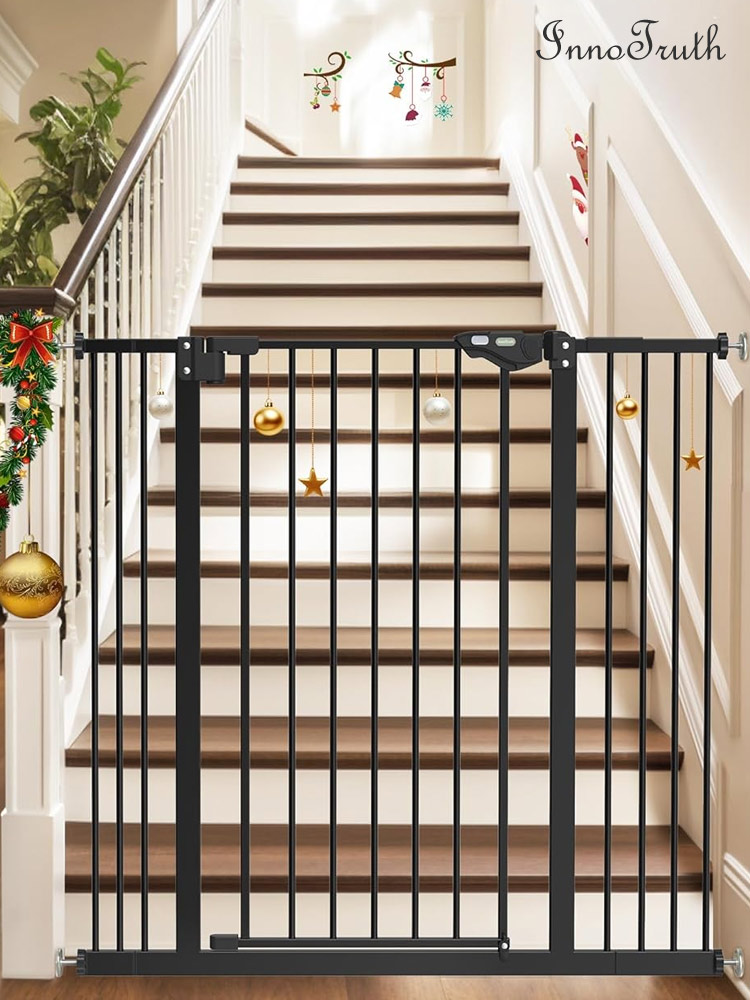 a tall innotruth baby gate in a home with stairs and holiday decorations