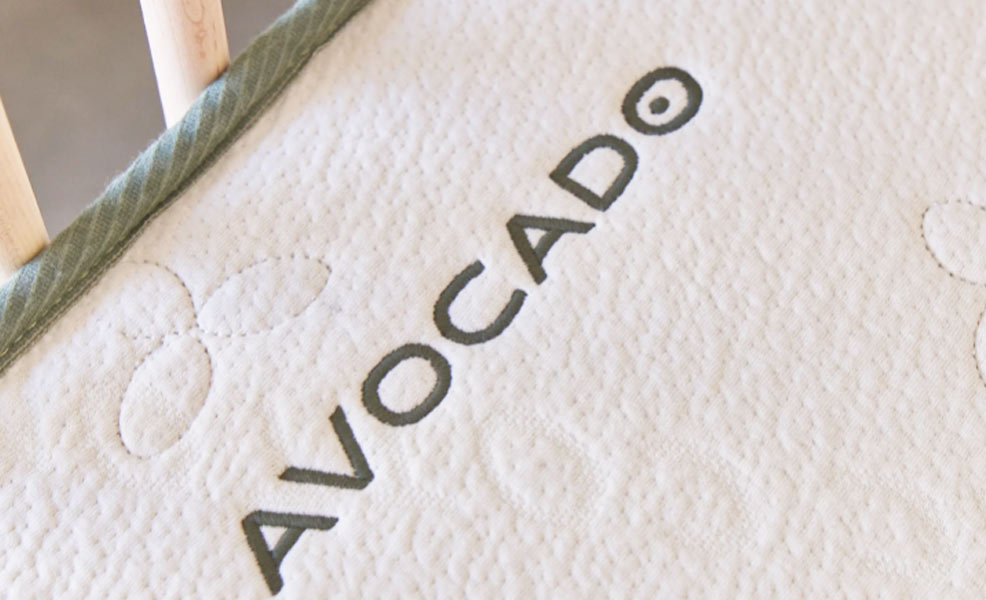 a close up of the avocado crib mattress in our testing