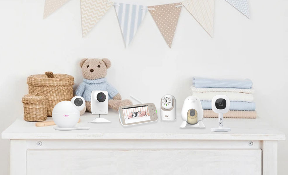 assortment of baby monitors arranged on top of a dresser in a nursery