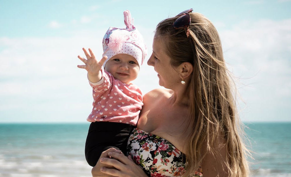 baby on beach with sunscreen