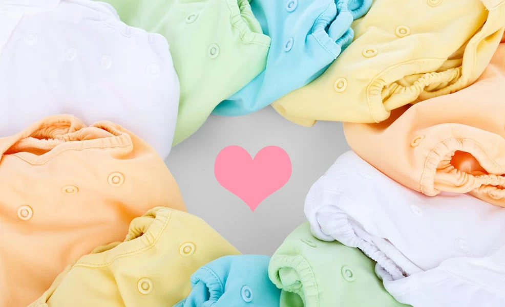 assortment of cloth diapers in different colors for testing