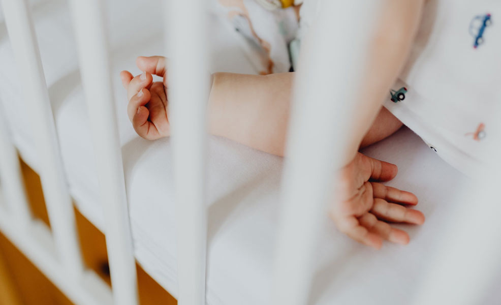 baby sleeping on a crib mattress