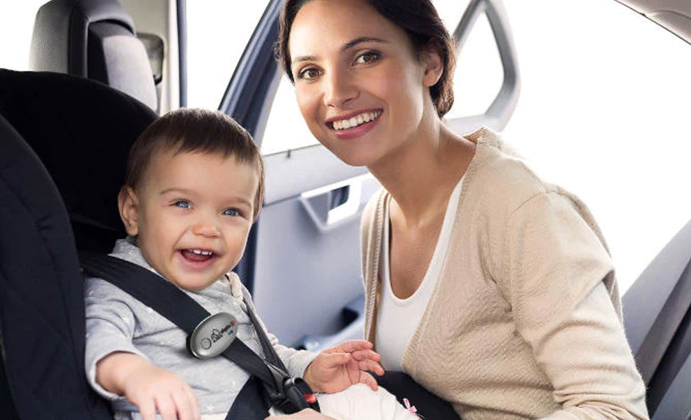 elepho eclip on a smiling baby in car seat with mom nearby