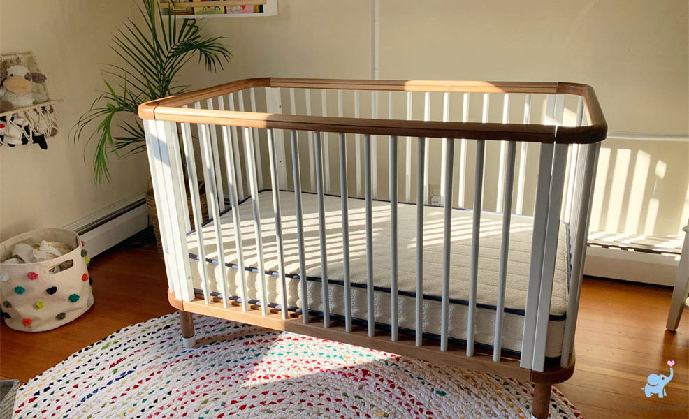 the emily crib mattress in a nestig crib in a nursery