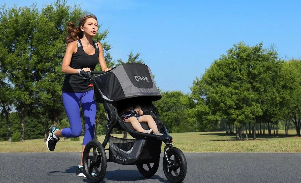 mom running with baby in jogging stroller