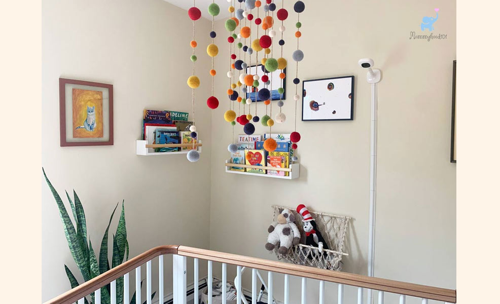 a nursery and crib with the nanit pro baby monitor overhead