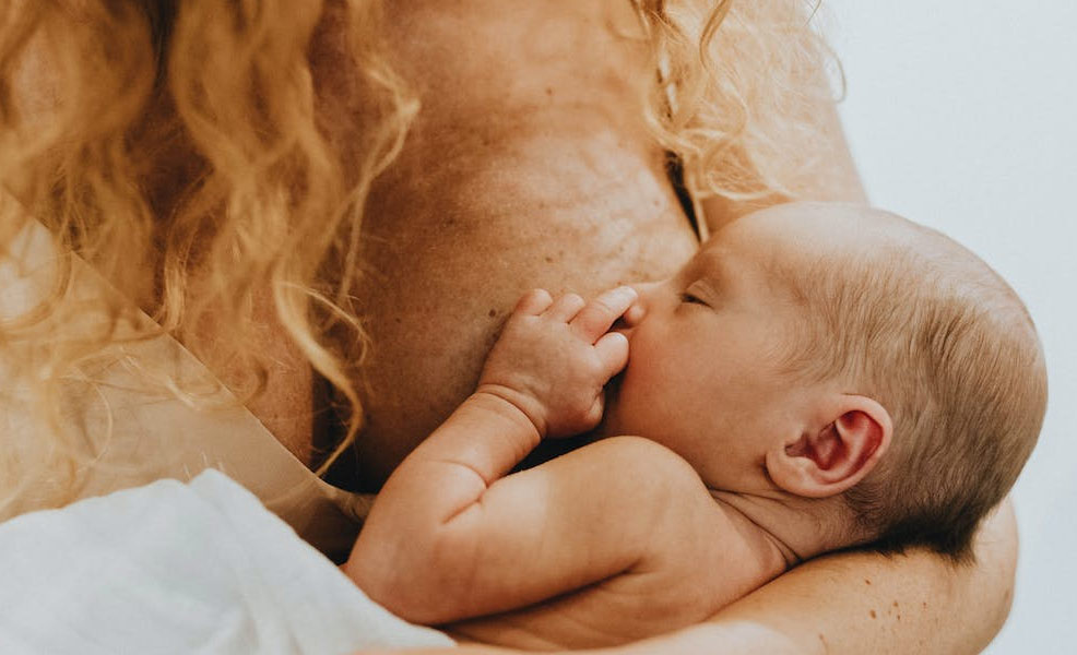 mom breastfeeding a baby needing nipple cream