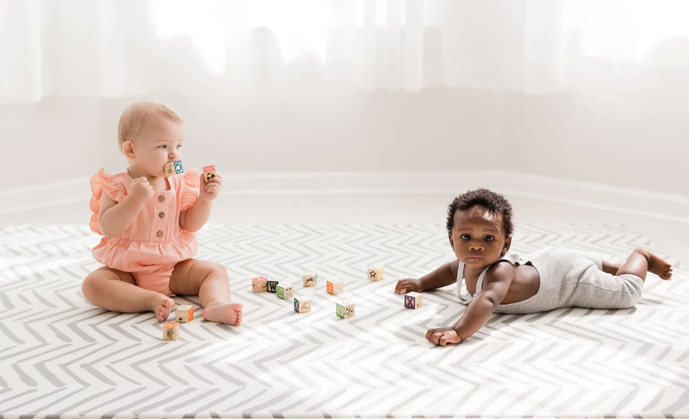 babies playing and tummy time on playmat