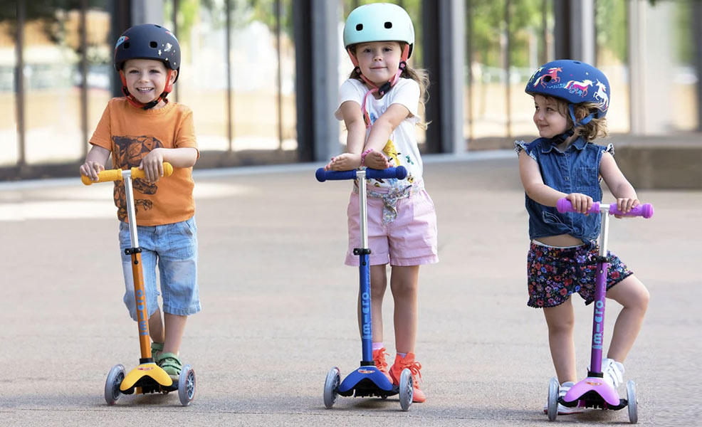 kids riding on micro kick scooters