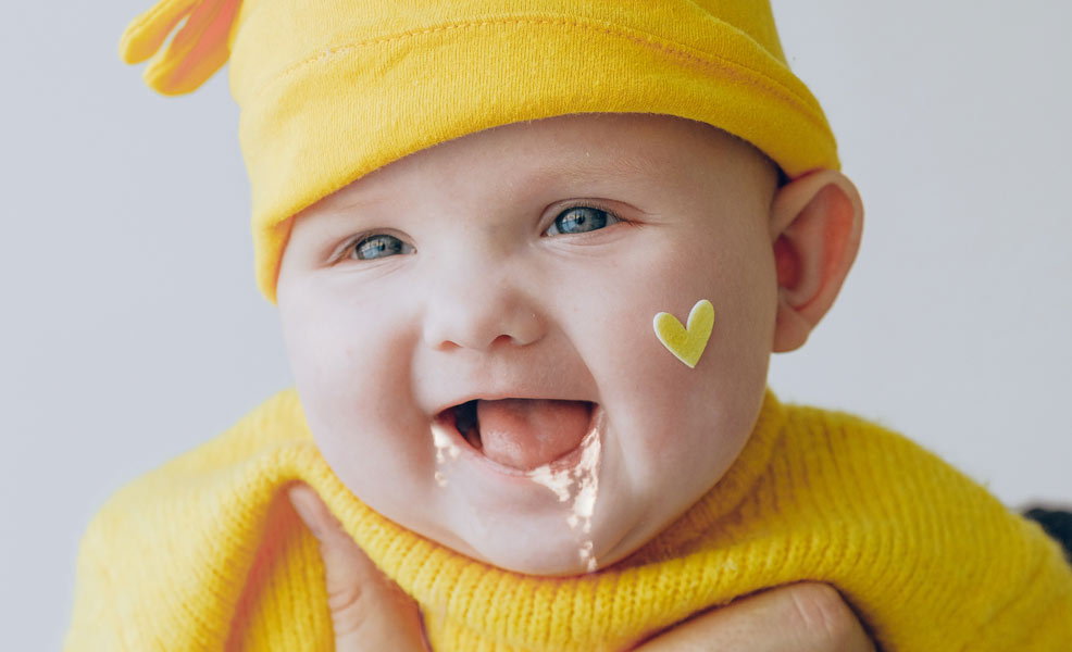 baby with spit up on face