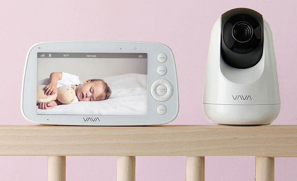 vava baby monitor sitting on the rail of a crib
