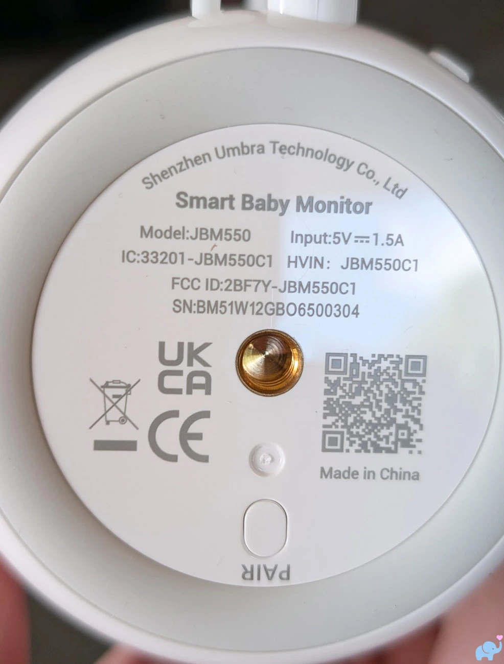 Bottom of the Jartoo JBM550 camera showing the model label pairing button QR code and universal tripod socket