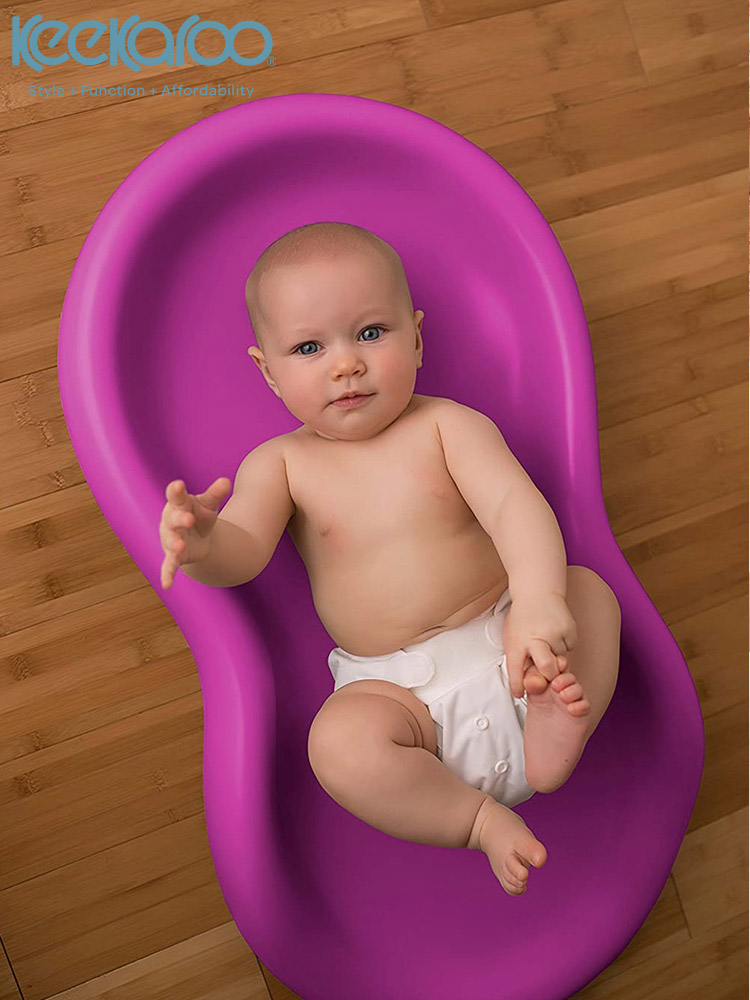 a baby laying on the keekaroo peanut changing pad