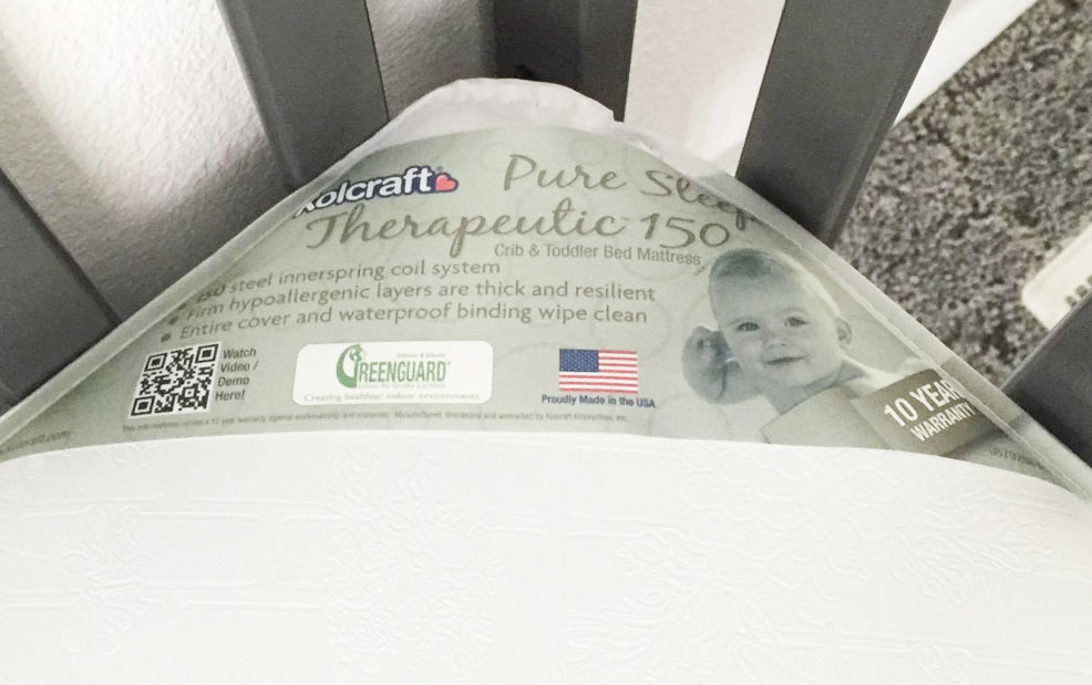 the kolcraft pure sleep therapeutic crib mattress placed into a crib