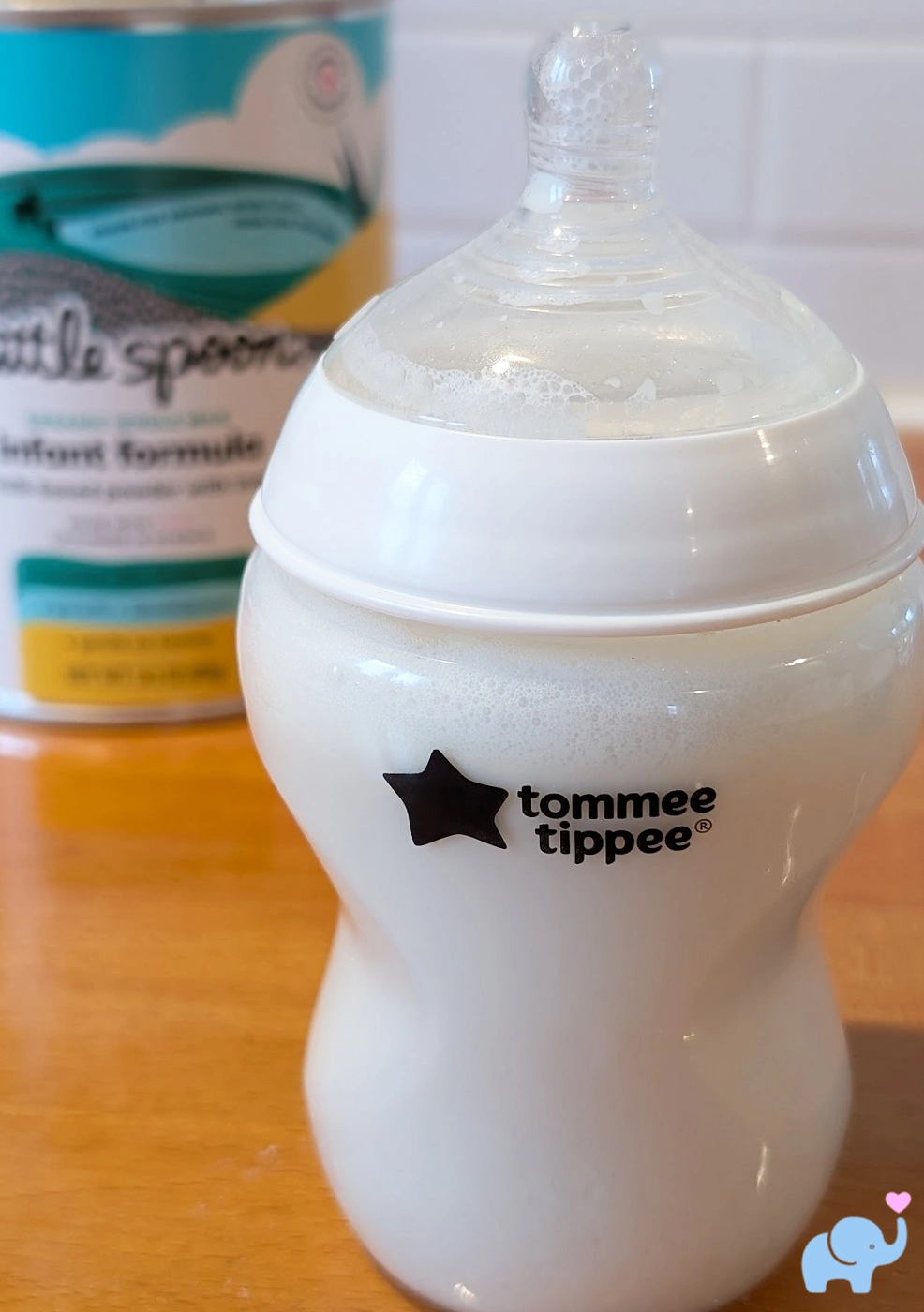 a Tommee Tippee baby bottle filled with 8 ounces of prepared Little Spoon formula showing minimal foam after mixing