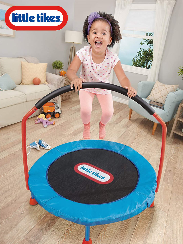 smiling girl jupming on the little tikes trampoline in the living room