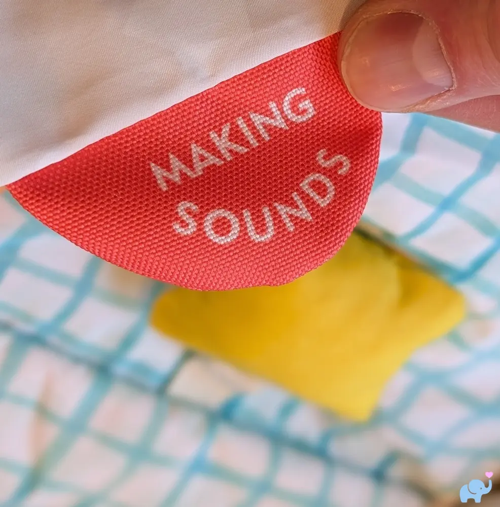 Exploring Sounds sensory panel with hanging sound toys on the Lovevery Play Gym