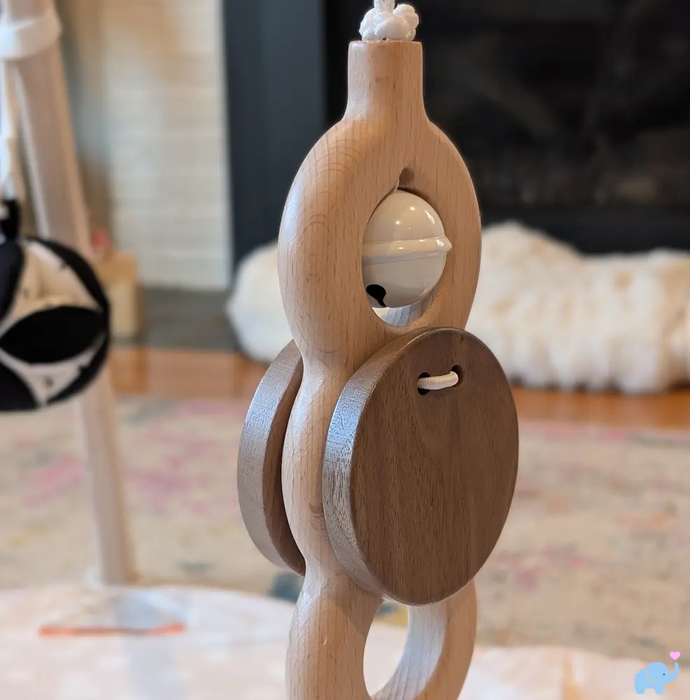 Primary wooden hanging toy on the Lovevery Play Gym