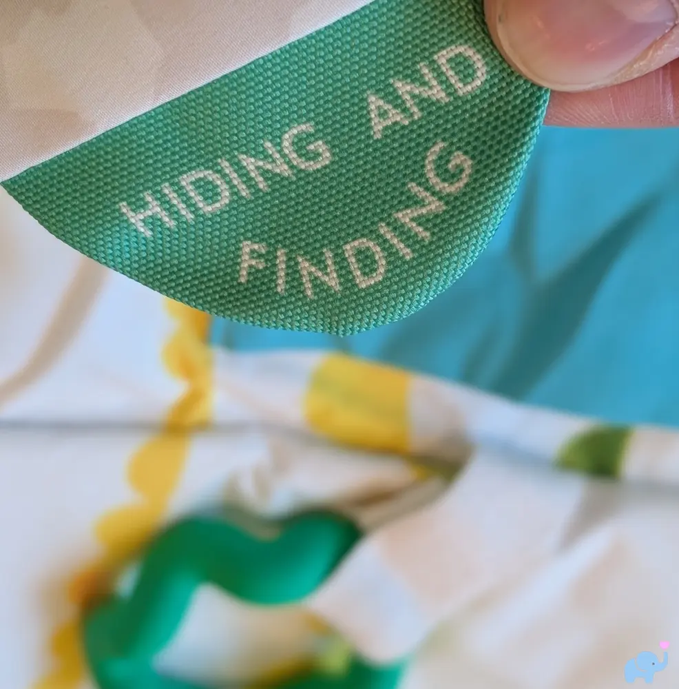 Hiding and Finding pocket with teething ring on the Lovevery Play Gym