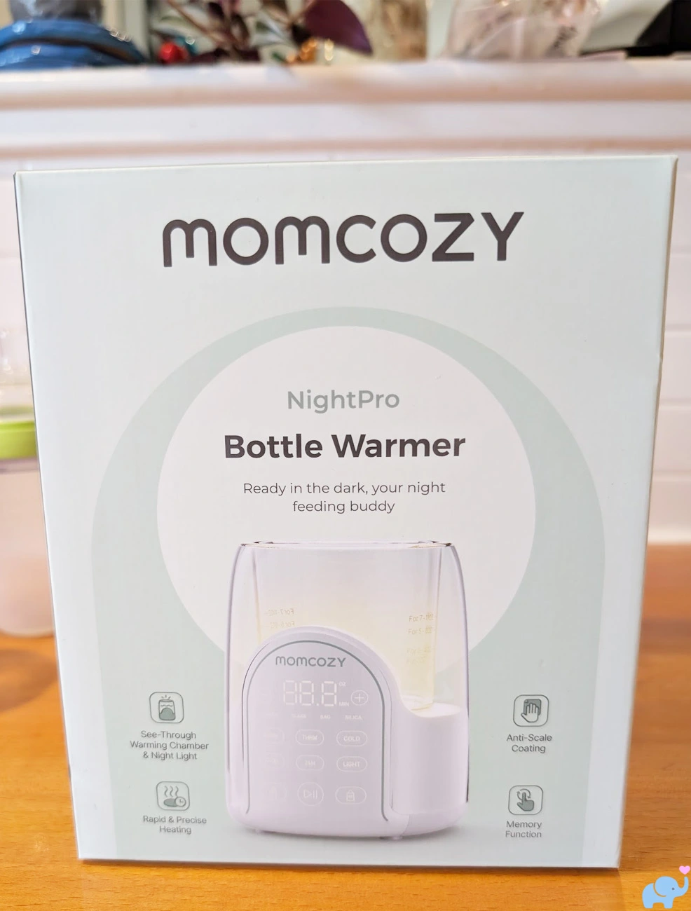 boxed Momcozy NightPro Baby Bottle Warmer package before unboxing