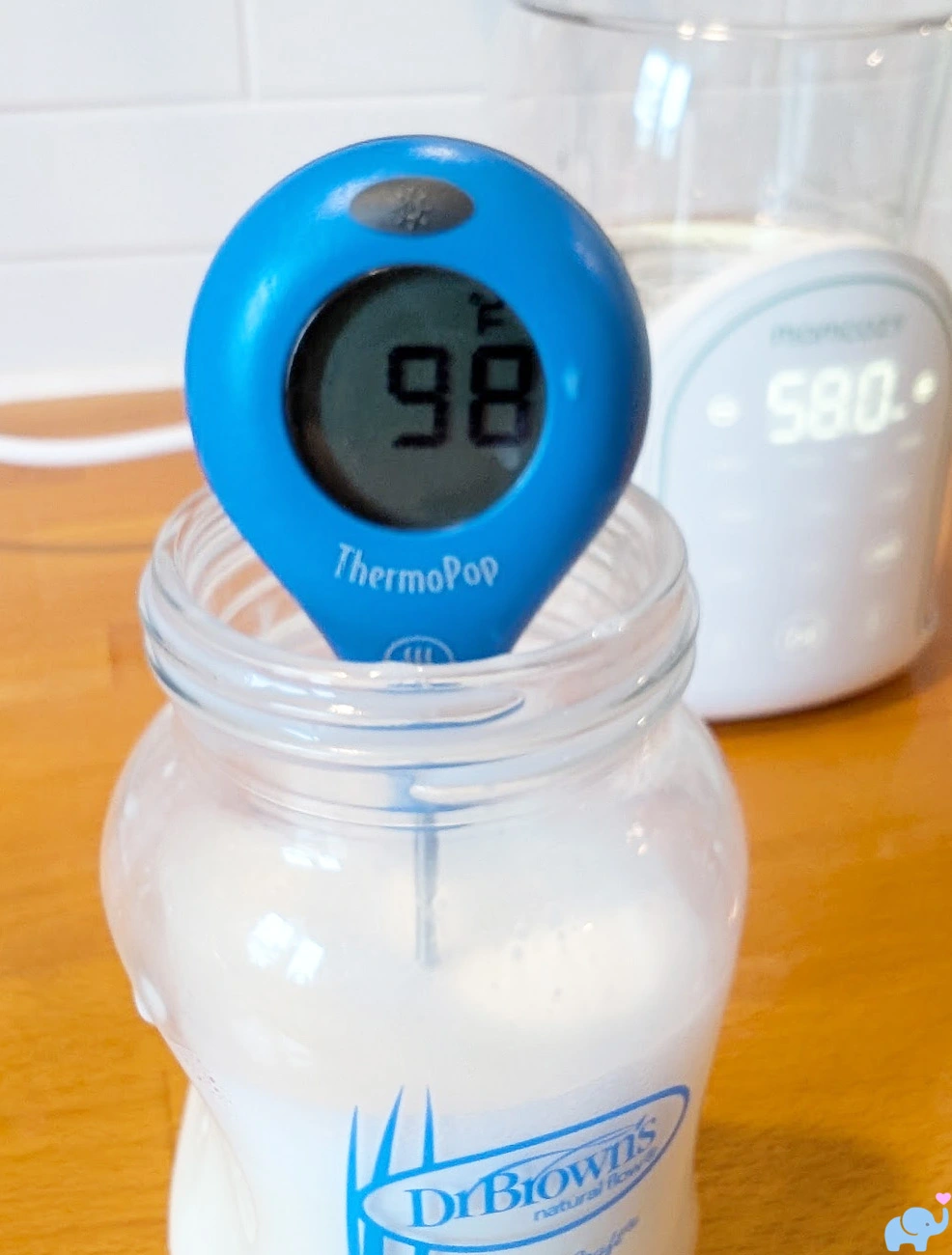 Dr Brown's glass baby bottle warmed to 98 degrees in the Momcozy NightPro Bottle Warmer