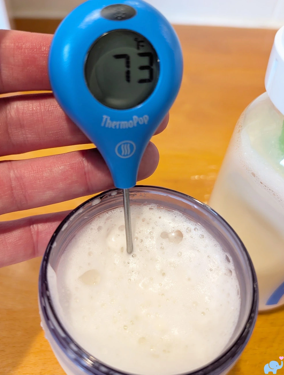 thermometer showing room temperature baby formula at 73 degrees before warming