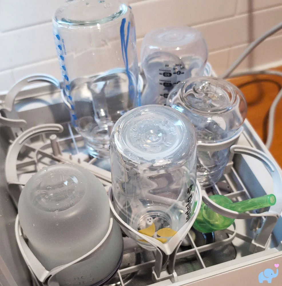 Clean and dry baby bottles on the bottom rack of the Momcozy DeepClean Baby Bottle Washer D8
