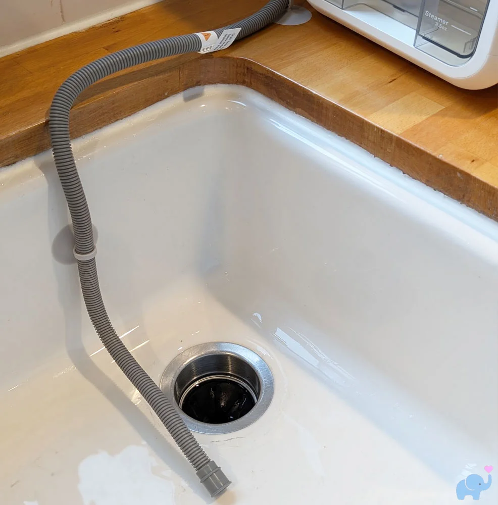 Momcozy DeepClean Baby Bottle Washer D8 drain hose secured in sink with suction cups