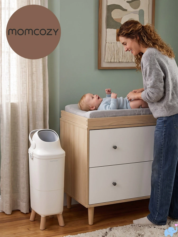 a mom changing a baby diaper in a nursery with the Momcozy Diaper Pail nearby