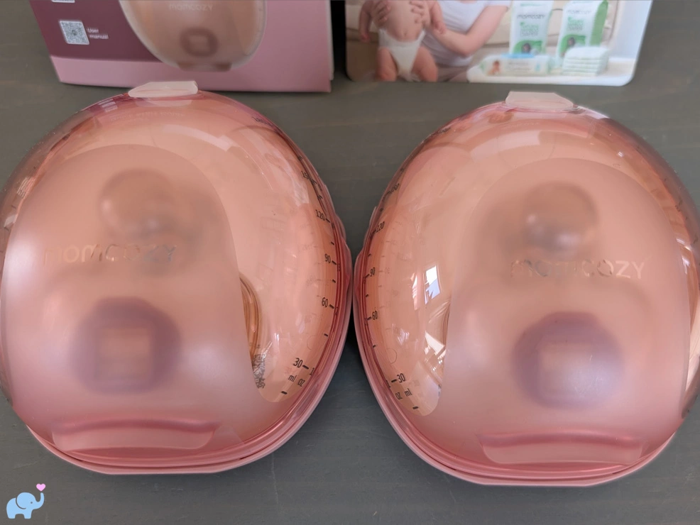 close up of the two Momcozy Wellness 1 breast pumps showing the transparent plastic top