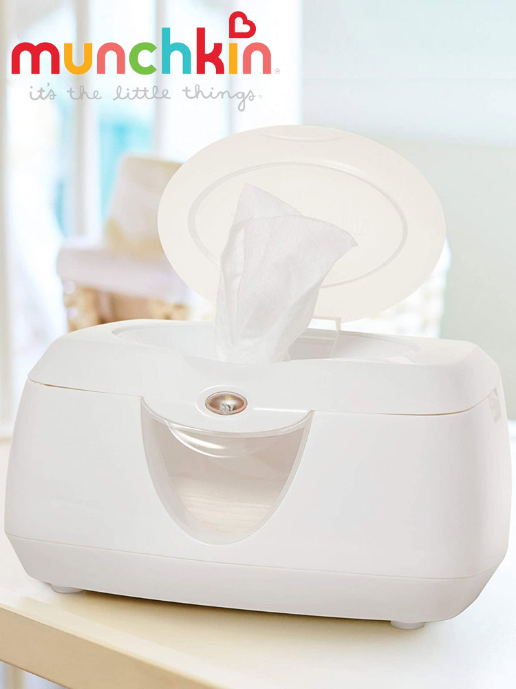 the munchkin glow wipe warmer with lid open and wipe being dispensed