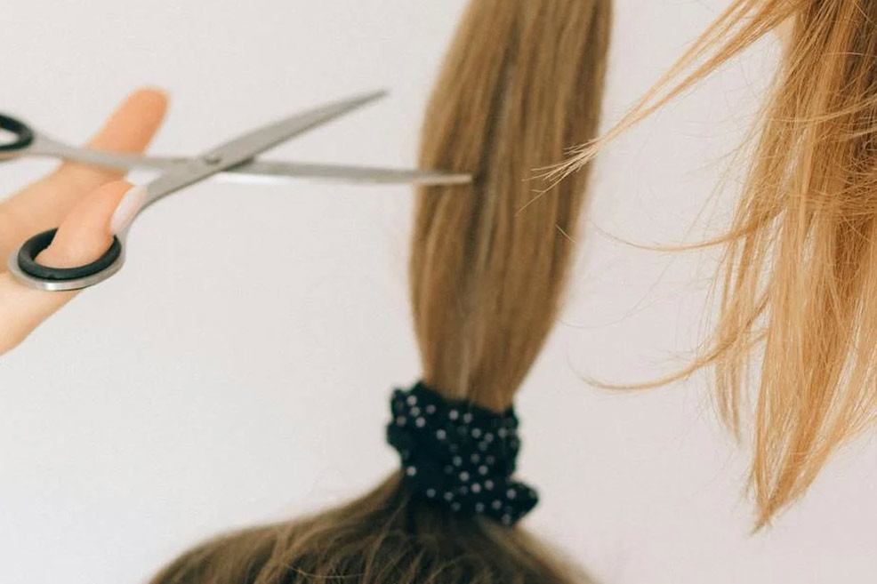 woman cutting her hair