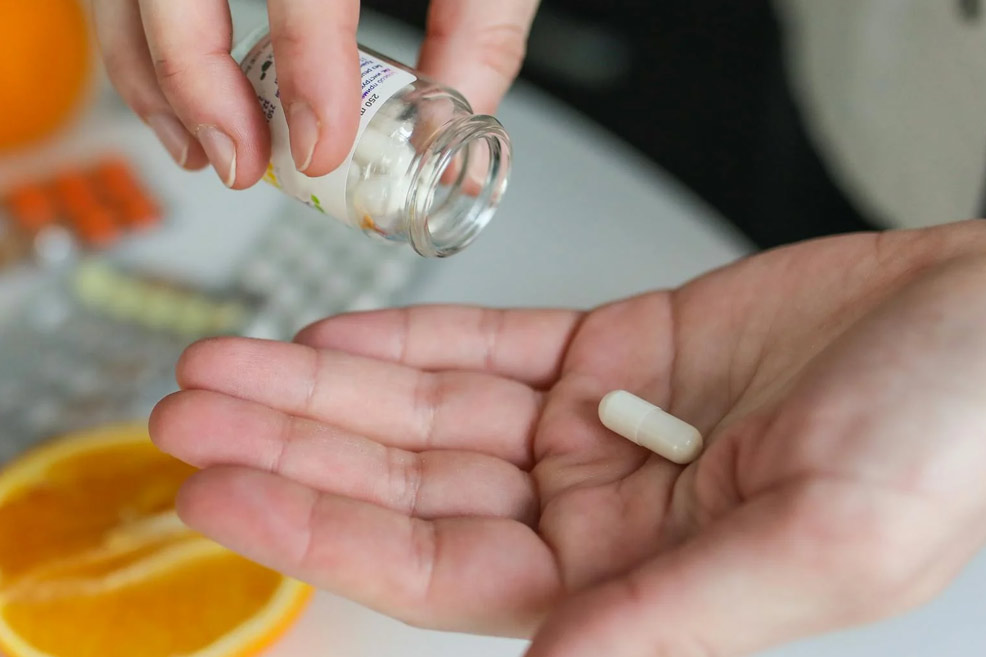 woman with hair loss supplements in her hand