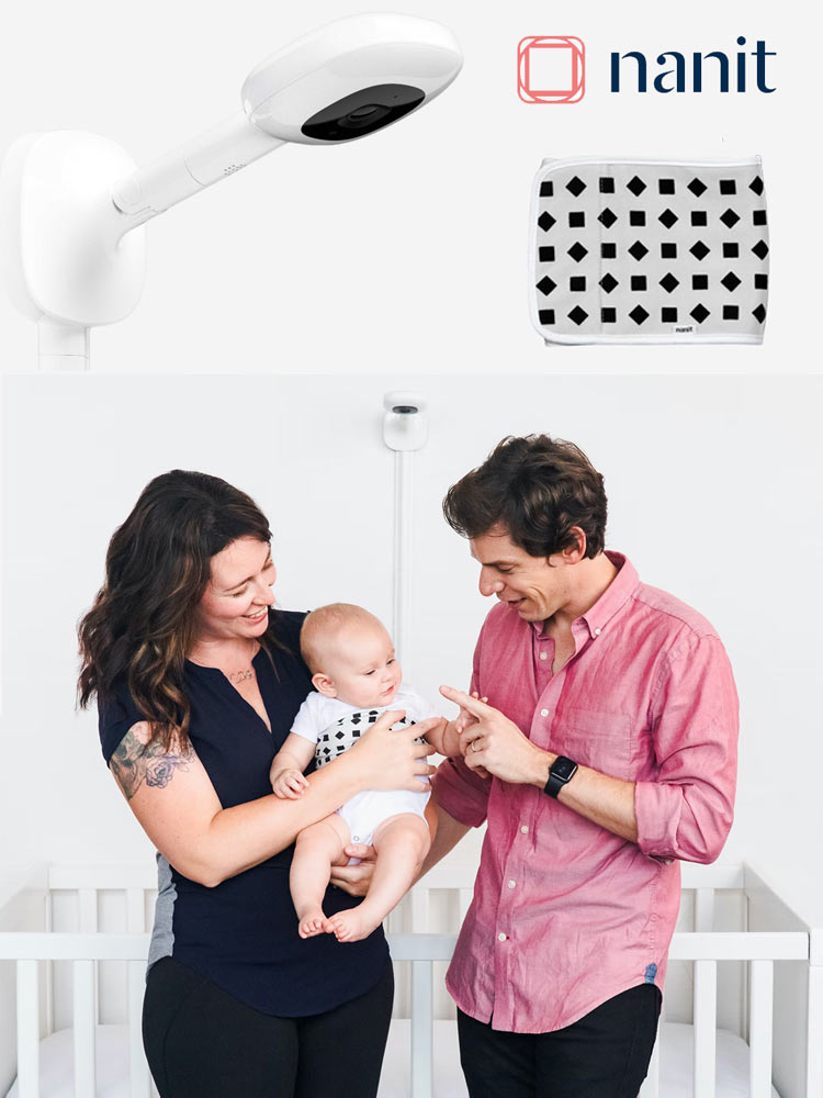 Nanit Pro baby monitor in the background with parents holding a baby