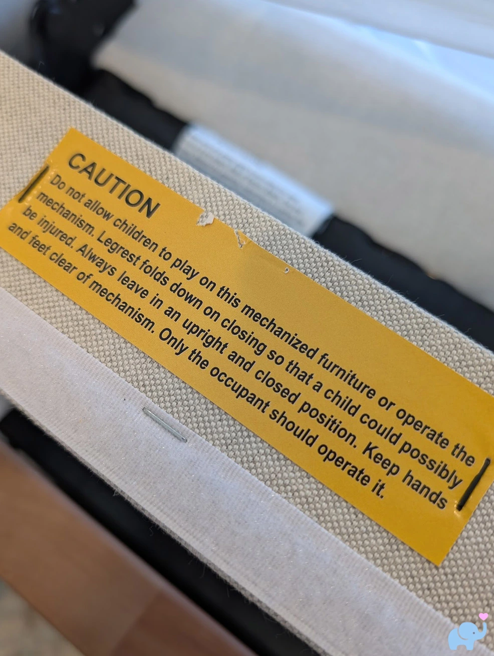 Nestig glider safety warning label on chair