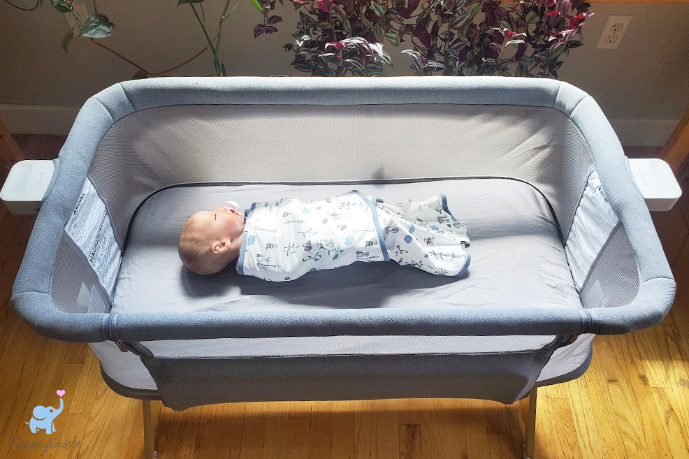 a baby sleeping in the newton bassinet