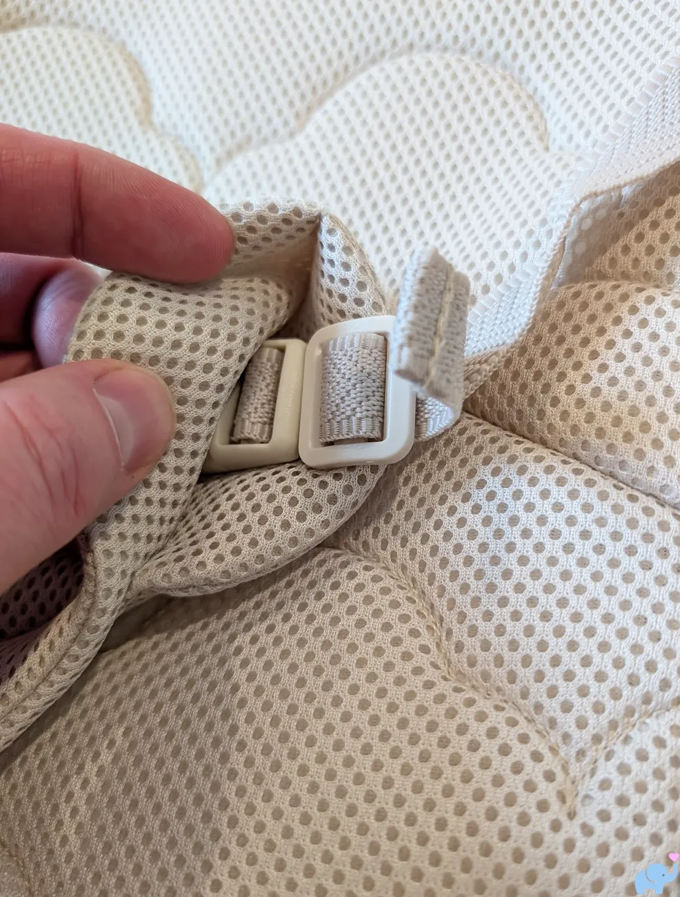 close up of Newton Baby Rocker adjustable three point harness and buckle