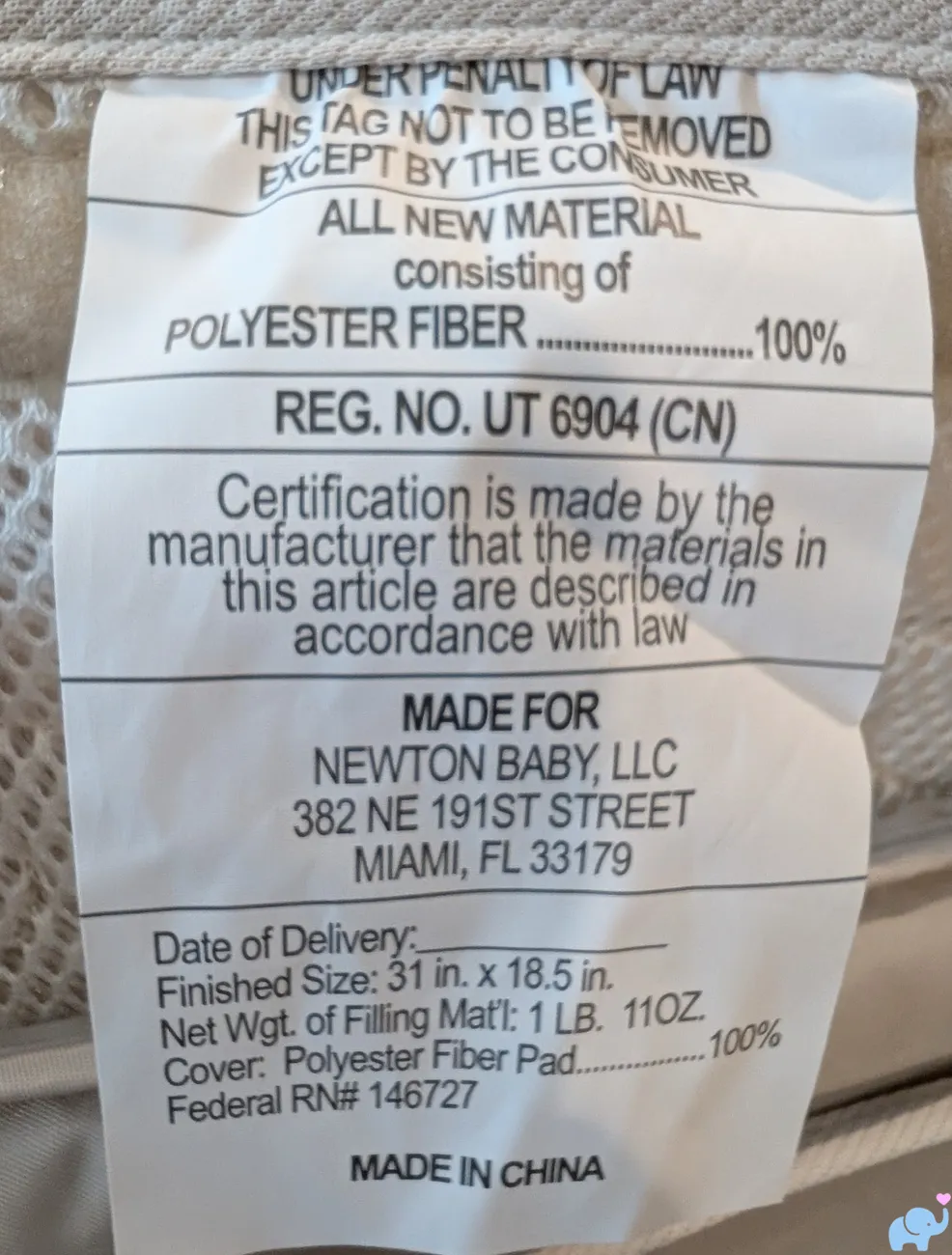 Newton Baby Rocker label showing fabric pad materials manufacturer information and finished size