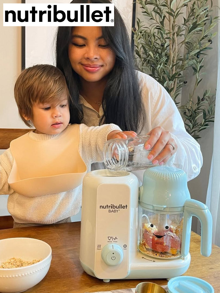 nutribullet steam and blend baby food maker on a counter with a mom and baby