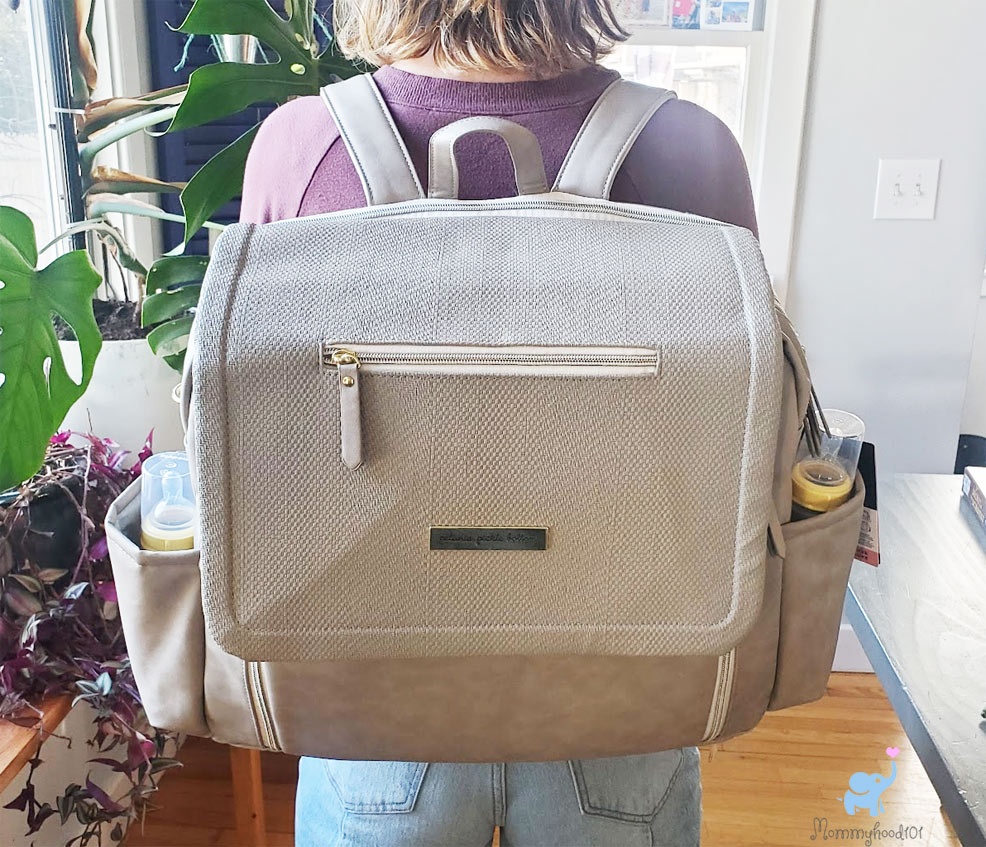 mom wearing the petunia pickle bottom boxy deluxe diaper bag