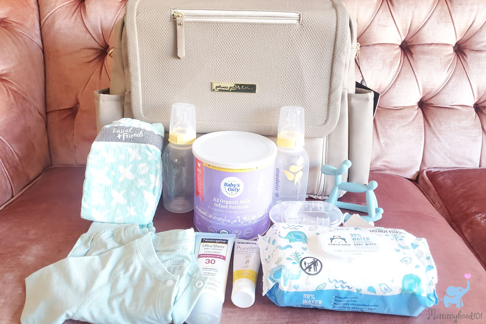 filling up the boxy deluxe diaper bag with baby products
