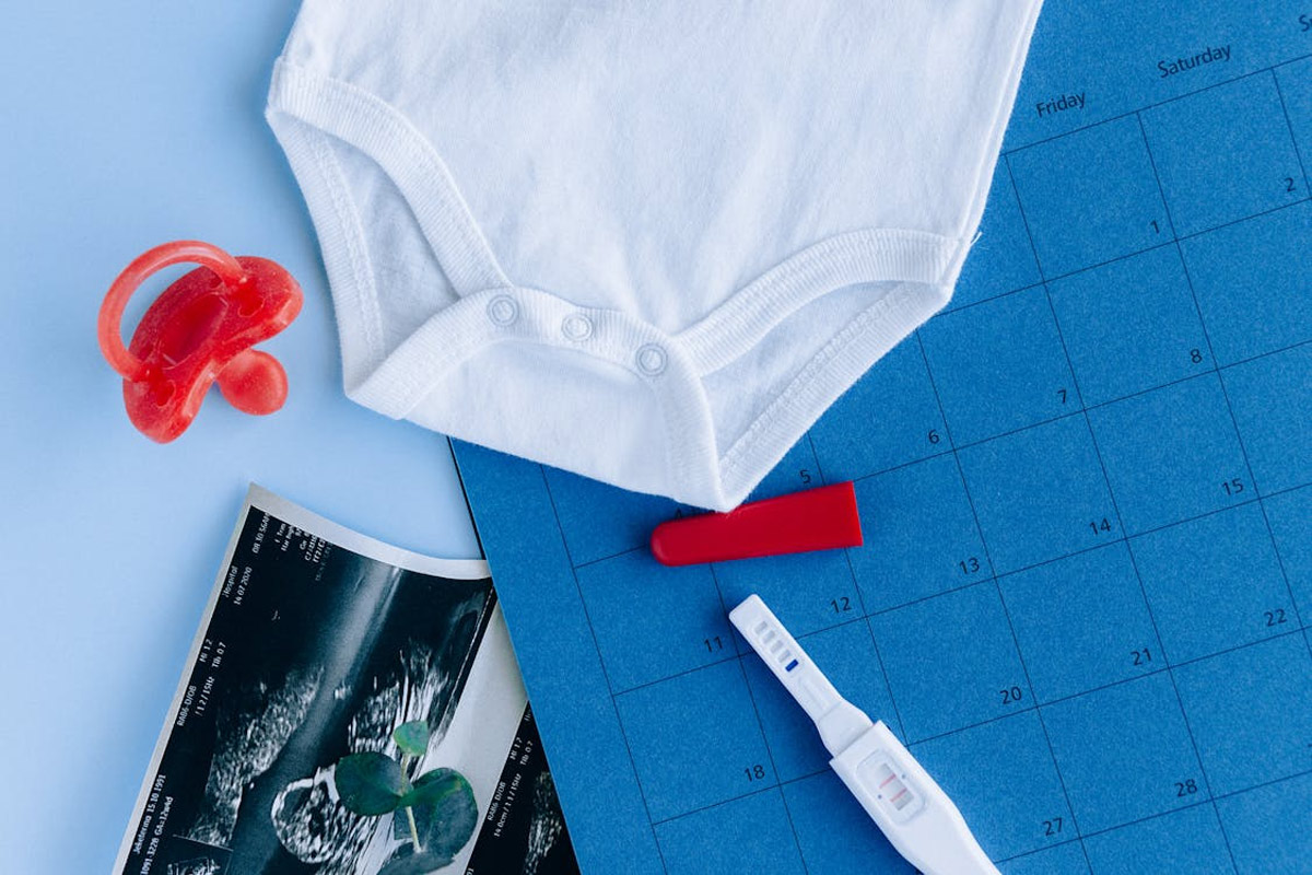 calendar with due date pregnancy test and pacifier