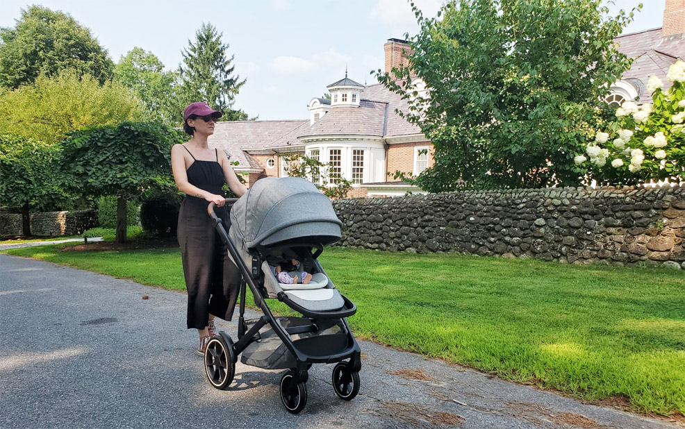 romer tura stroller on street with baby