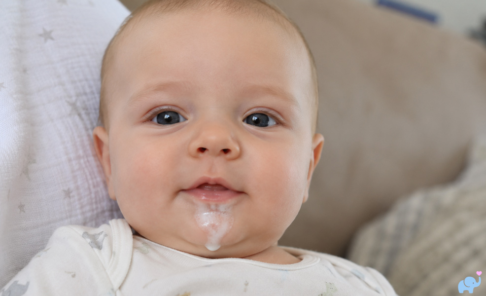 young baby with spit-up on chin