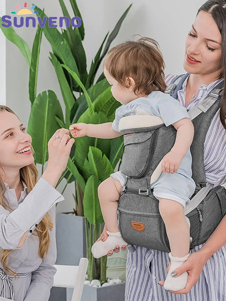 a mother carrying a baby using the Sunveno hip seat baby carrier
